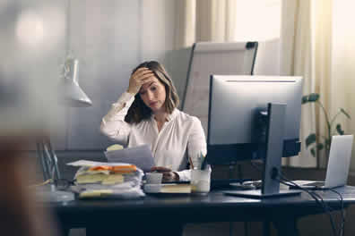 female-ceo-frustrated-looking-at-health-insurance-packet